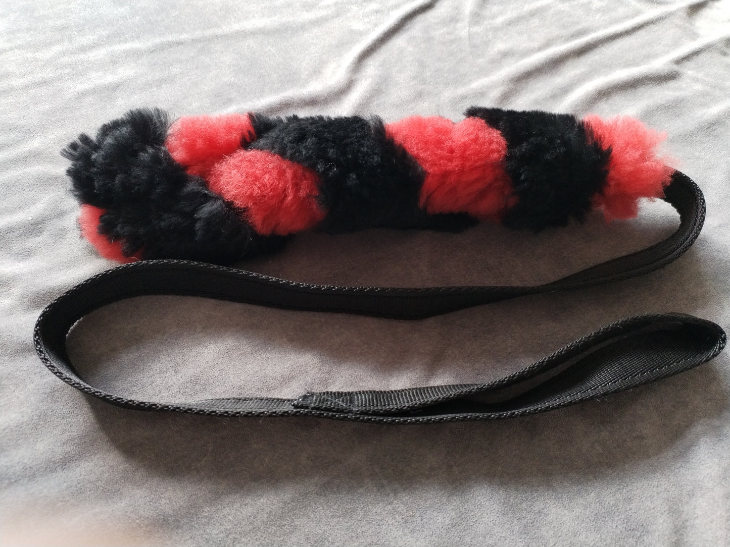 Red and Black Sheepskin Tug Toy.